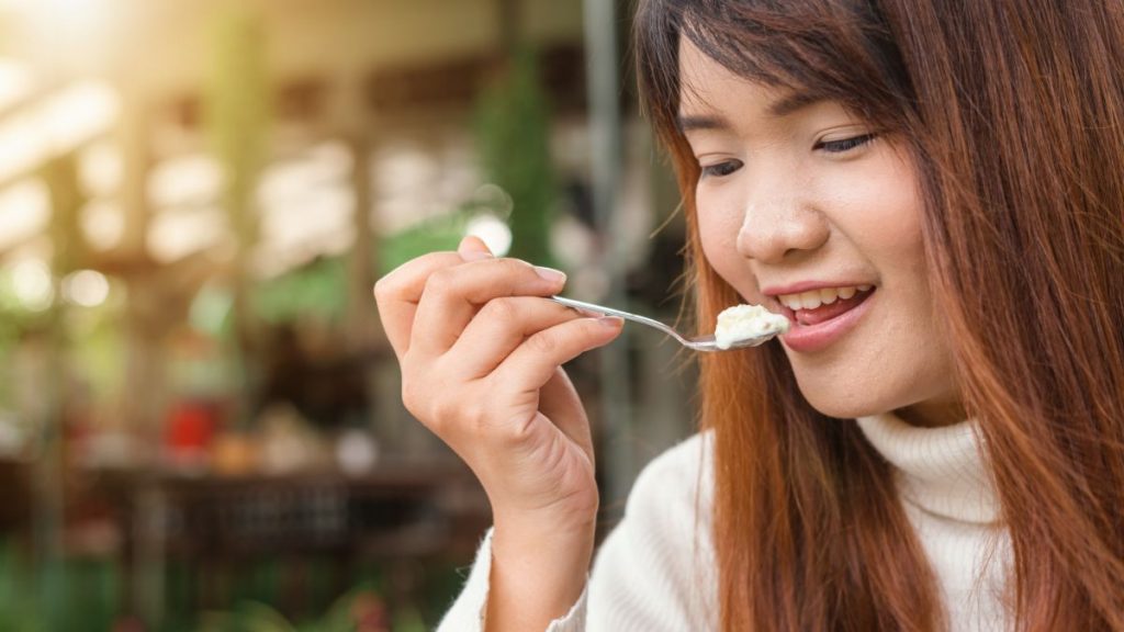 Woman eating as mystery shopper