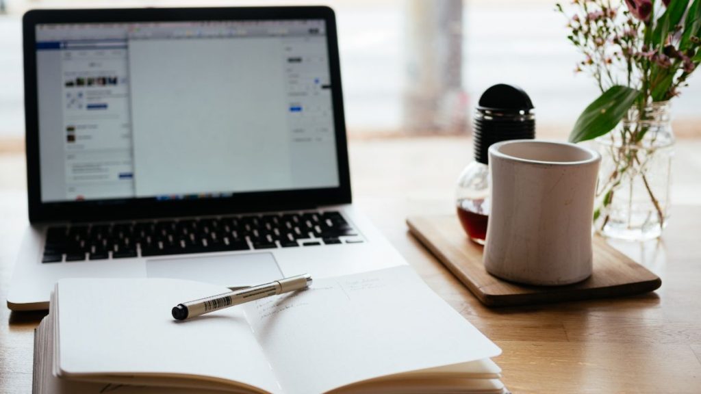 WFH Laptop on desk with book