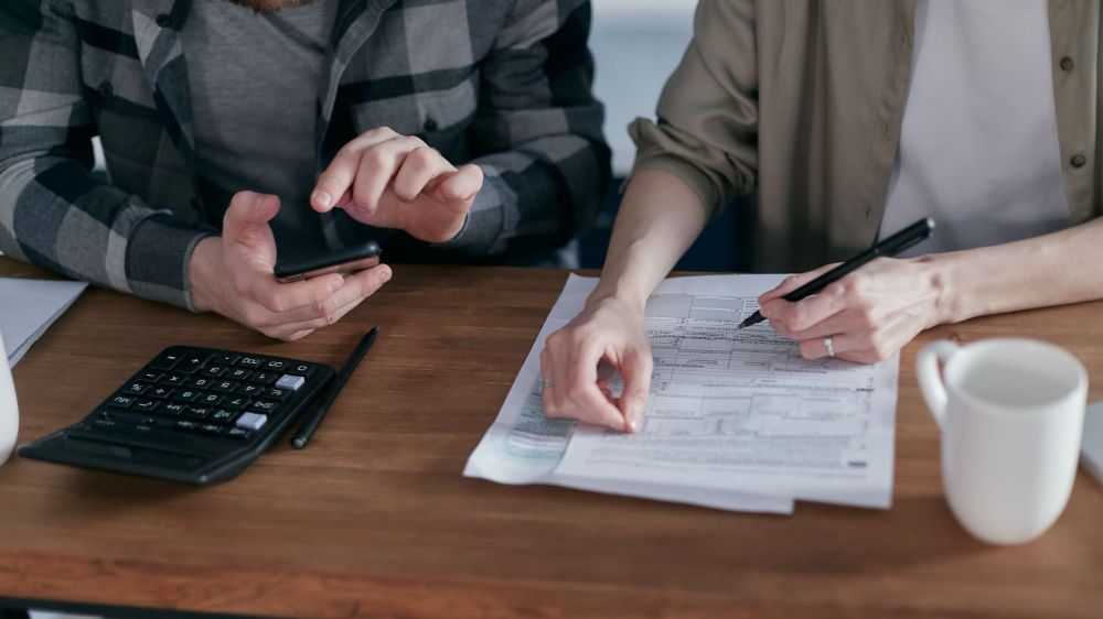 Man and woman working on SE taxes