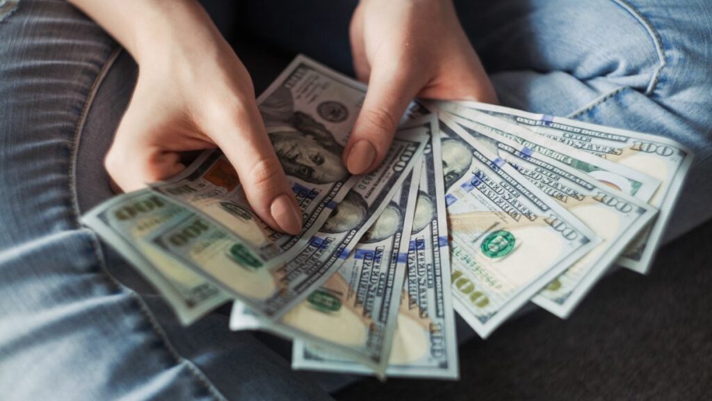 Hands holding money from personal loan