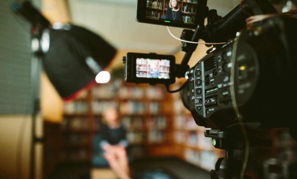 Woman videoing a video resume with her iphone