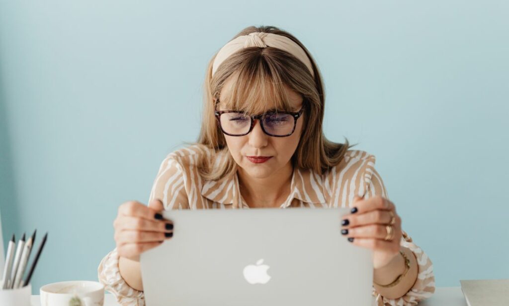 Woman looking at laptop searching for LLC information