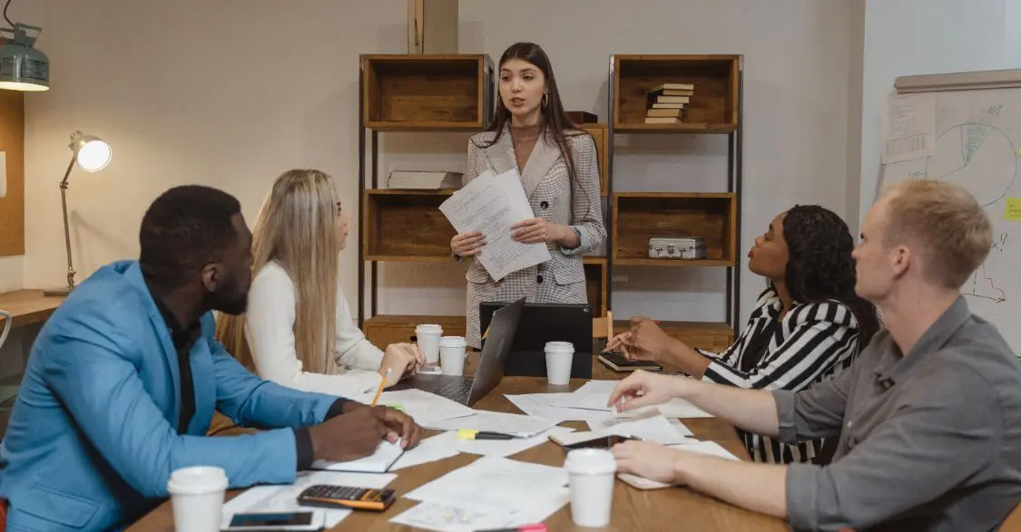 Confident woman presenting at a group meeting