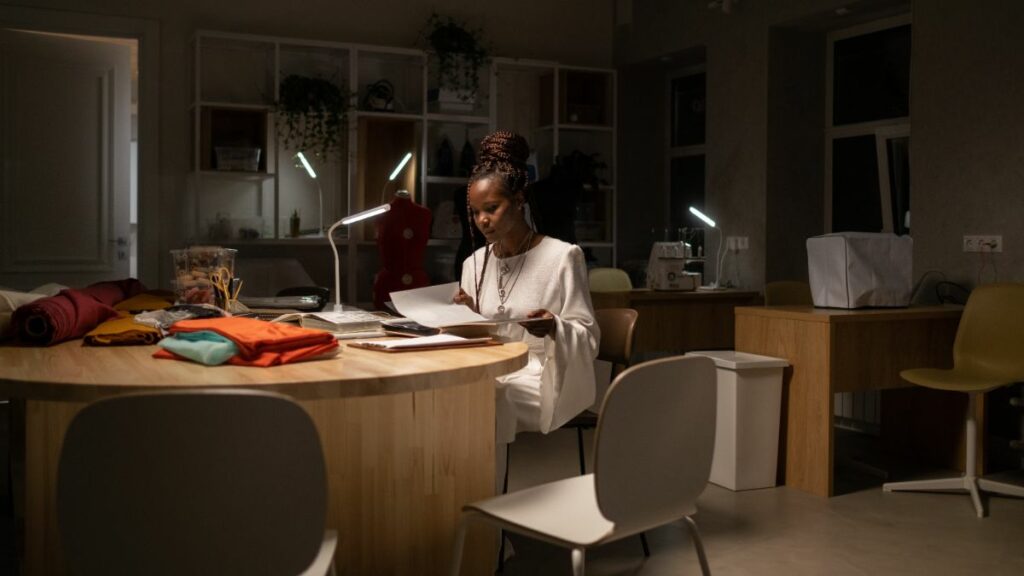 African american woman sitting alone at office in dim light